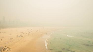 Bondi Beach obscured by a thick layer of smoke
