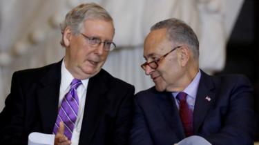 Senate Majority Leader Mitch McConnell and Senate Minority Leader Chuck Schumer talk during a ceremony in Washington, US, 25 October, 2017.