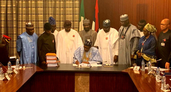 Photos: President Buhari signs 2020 budget into law