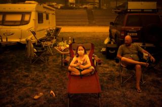 A family sit at a showground