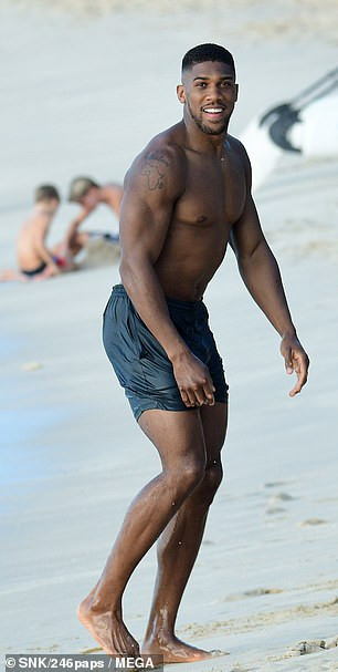 Anthony Joshua shows off his muscular physique during beach day in Barbados (Photos)