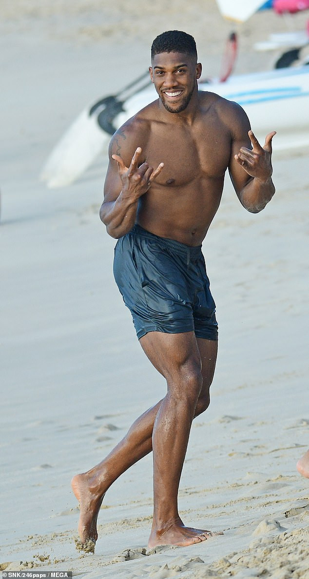 Anthony Joshua shows off his muscular physique during beach day in Barbados (Photos)