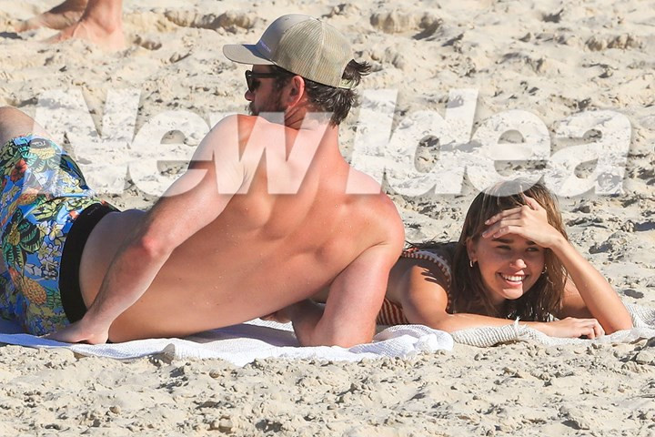 Liam Hemsworth confirms romance with model Gabriella Brooks as they kiss on the beach