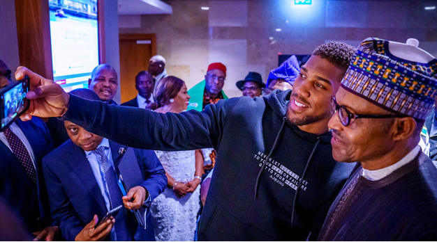 Anthony Joshua prostrates as he presents his World Heavy Championship belts to President Buhari in London (Photos)