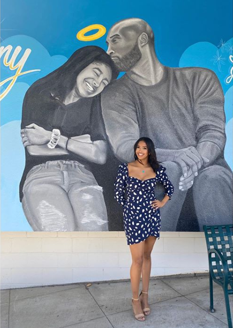 Vanessa Bryant and her daughters pose next to a mural of Kobe and Gigi Bryant