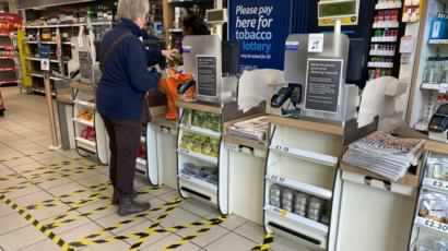Taped-off areas for customers distance themselves from each other are seen at the checkout till area of a local Tesco store as the number of coronavirus disease cases (COVID-19) grow around the world, in London, Britain, March 21, 2020. REUTERS/Toby Melville