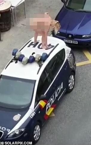 Woman strips naked and jumps on police car after leaving court for breaching lockdown order