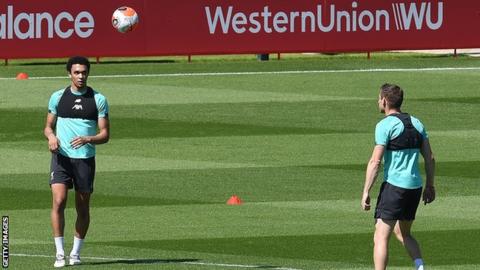 Liverpool players Trent Alexander-Arnold (left) and James Milner (right) take part in non-contact training at Melwood