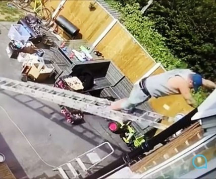 Painful moment man fell from the roof of a building after his ladder slipped (video)