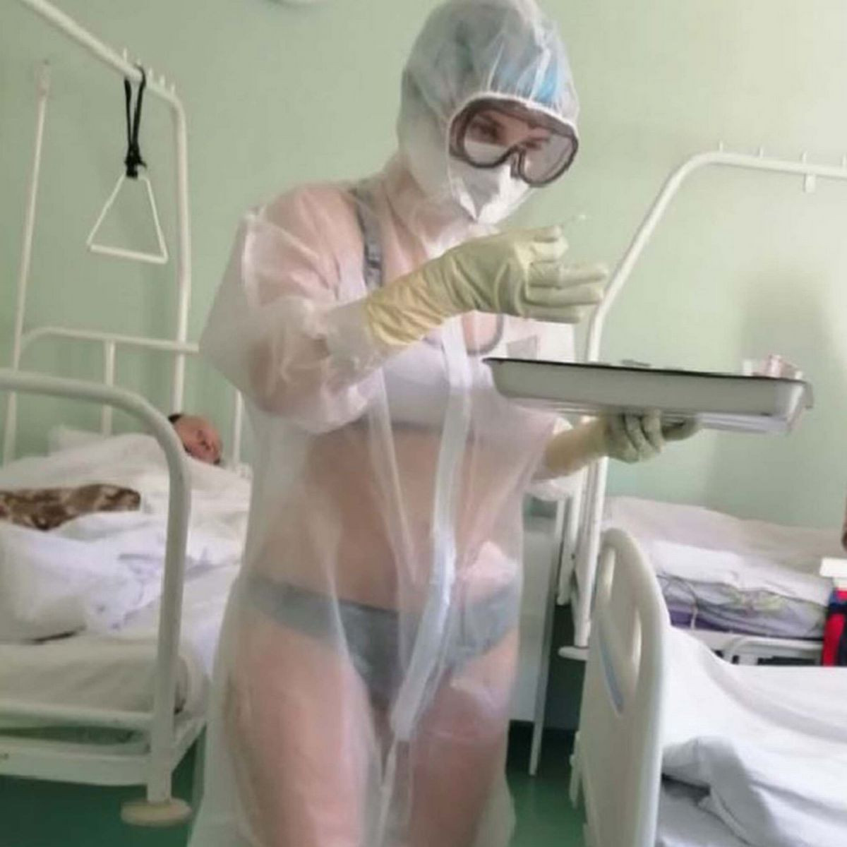 Politicians defend Nurse who wore only underwear under see-through PPE gown in male hospital ward as new image emerges