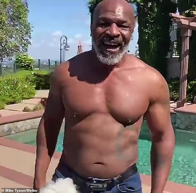 53 year old Mike Tyson shows off toned physique and abs while throwing punches as he prepares for boxing comeback (Photos/video)