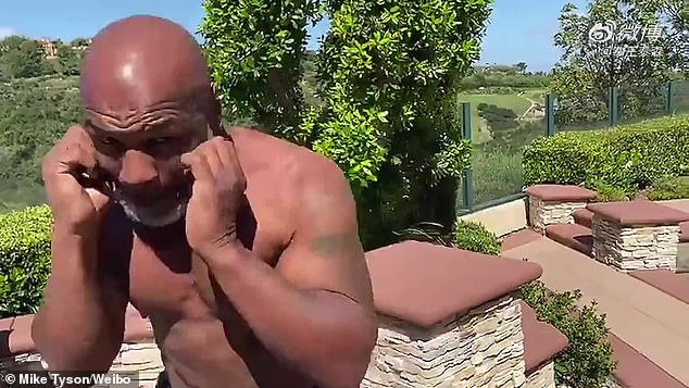 53 year old Mike Tyson shows off toned physique and abs while throwing punches as he prepares for boxing comeback (Photos/video)