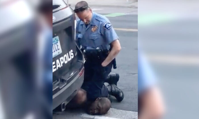 New video shows three Minneapolis officers kneeling on George Floyd before he died