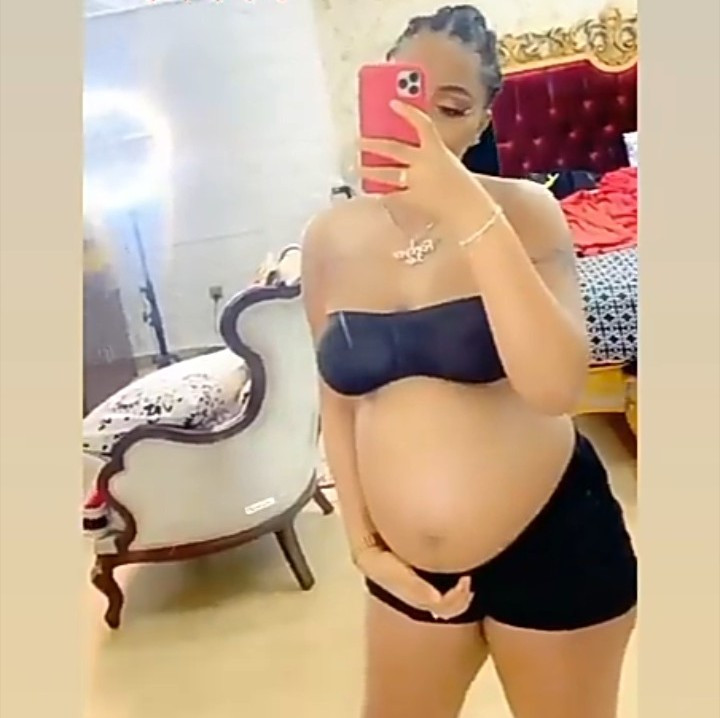Regina Daniels flaunts bare baby bump as she releases more photos and videos following her pregnancy announcement