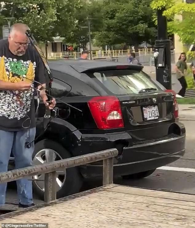 Man beaten for shooting arrows at protesters, car burned (video)