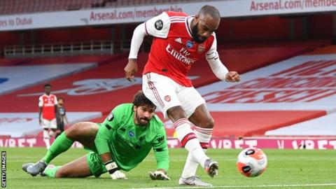 Alexandre Lacazette rounds Alisson to score