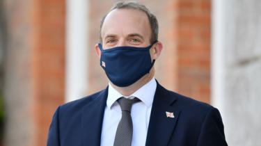 Foreign Secretary Dominic Raab wearing a face mask waits for the French and German foreign ministers to arrive for an E3 Ministers meeting at Chevening House in Sevenoaks, Kent