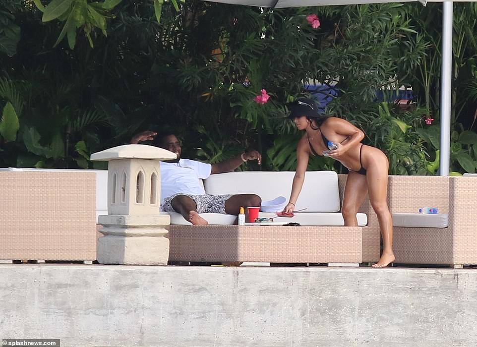 Hip-pop mogul, Diddy spotted with mystery woman at his Miami Beach mansion days after he was pictured kissing model Tina Louise (Photos)