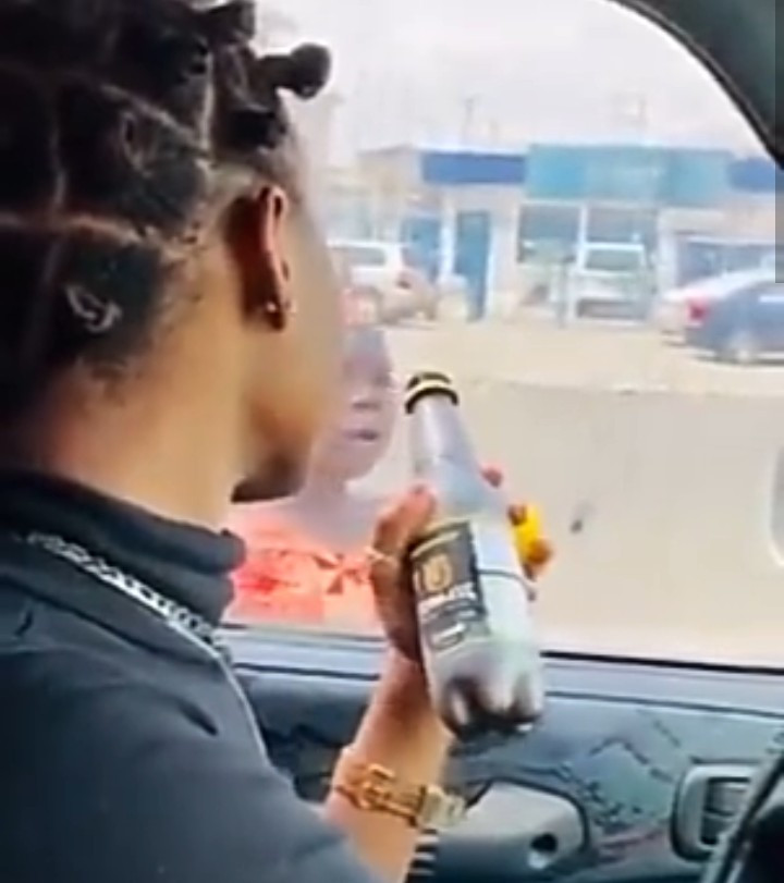 Outrage as influencer entices child beggar with a bottle of drink then leaves her hanging (video)