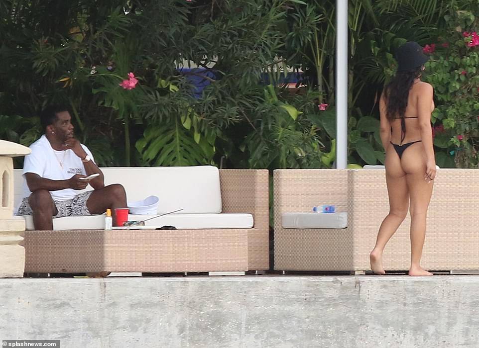 Hip-pop mogul, Diddy spotted with mystery woman at his Miami Beach mansion days after he was pictured kissing model Tina Louise (Photos)