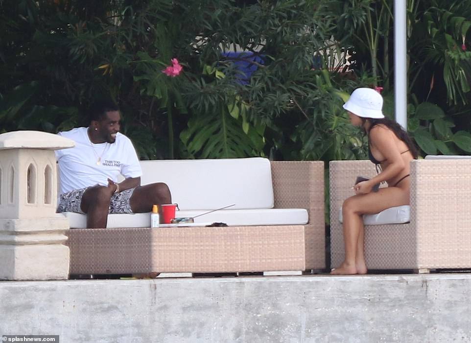 Hip-pop mogul, Diddy spotted with mystery woman at his Miami Beach mansion days after he was pictured kissing model Tina Louise (Photos)
