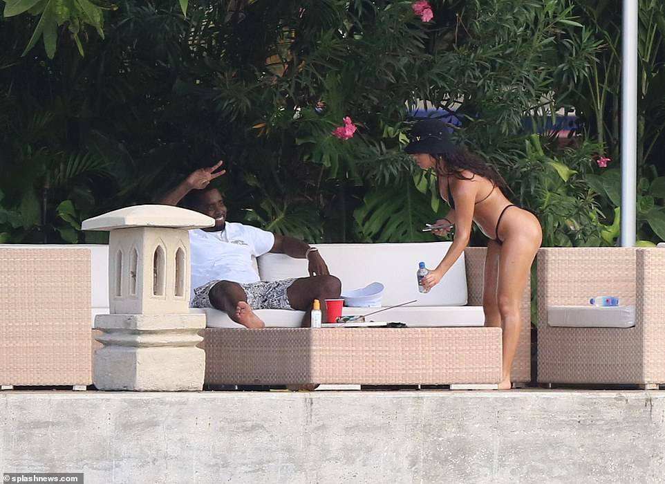 Hip-pop mogul, Diddy spotted with mystery woman at his Miami Beach mansion days after he was pictured kissing model Tina Louise (Photos)