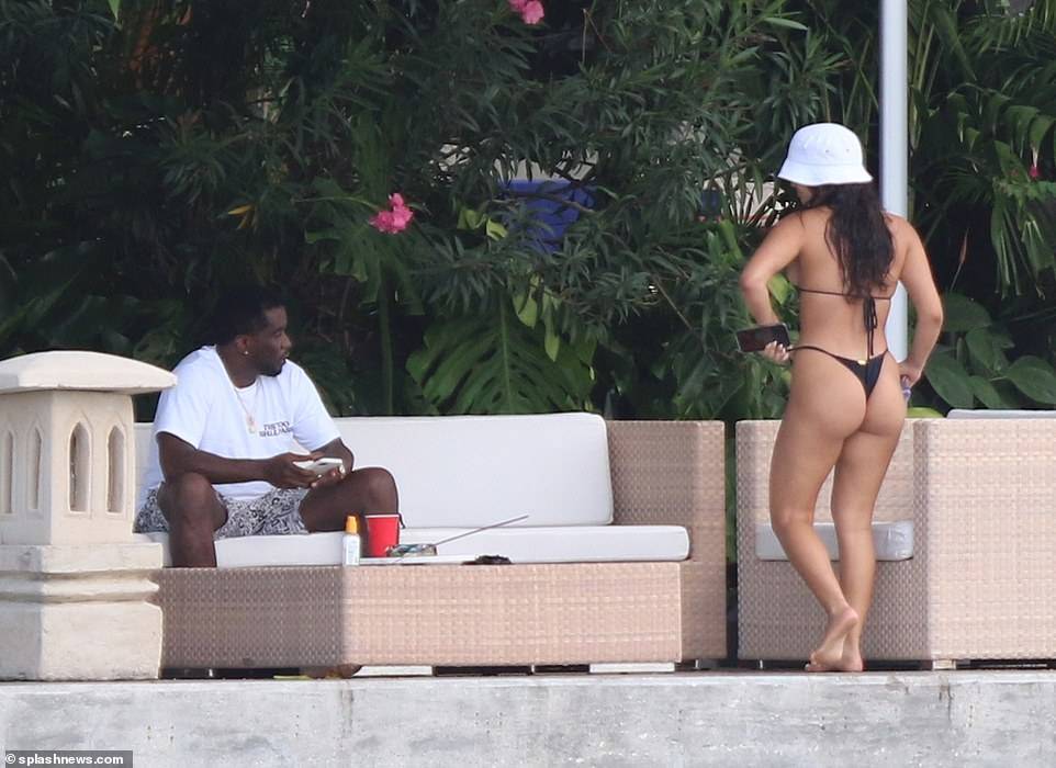 Hip-pop mogul, Diddy spotted with mystery woman at his Miami Beach mansion days after he was pictured kissing model Tina Louise (Photos)