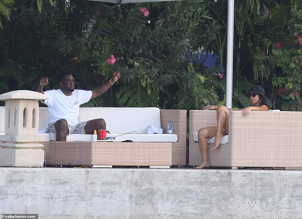 Hip-pop mogul, Diddy spotted with mystery woman at his Miami Beach mansion days after he was pictured kissing model Tina Louise (Photos)