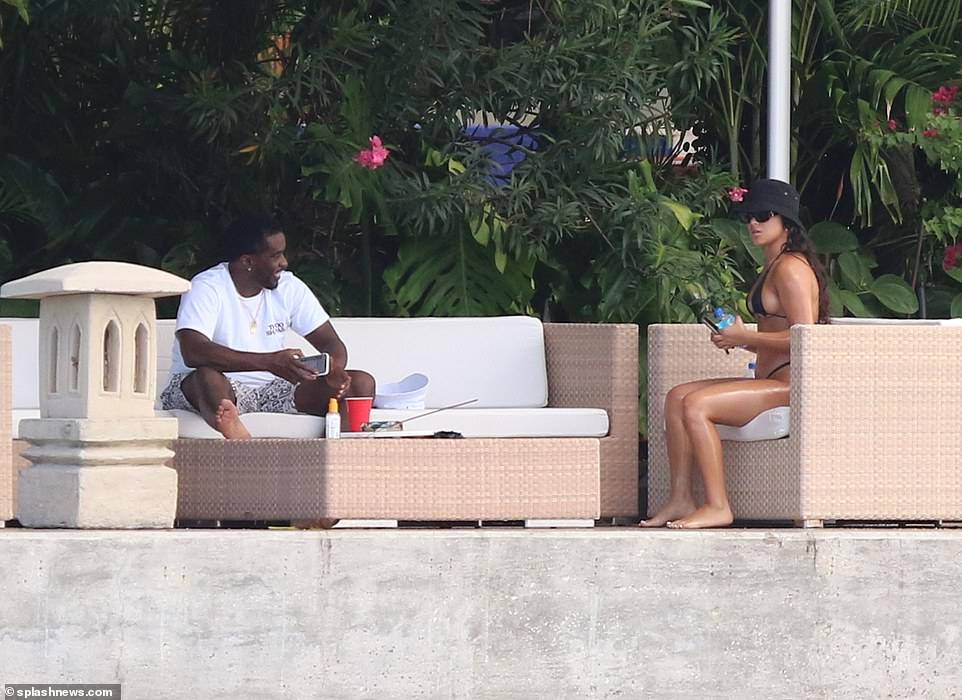 Hip-pop mogul, Diddy spotted with mystery woman at his Miami Beach mansion days after he was pictured kissing model Tina Louise (Photos)
