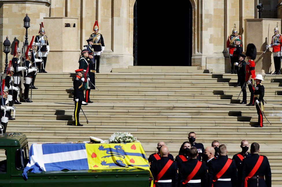 The Duke of Edinburgh's coffin, covered with His Royal Highness's Personal Standard arrives at St George's Chapel during the funeral of Prince Philip, Duke of Edinburgh at Windsor Castle on April 17, 2021 in Windsor, England.