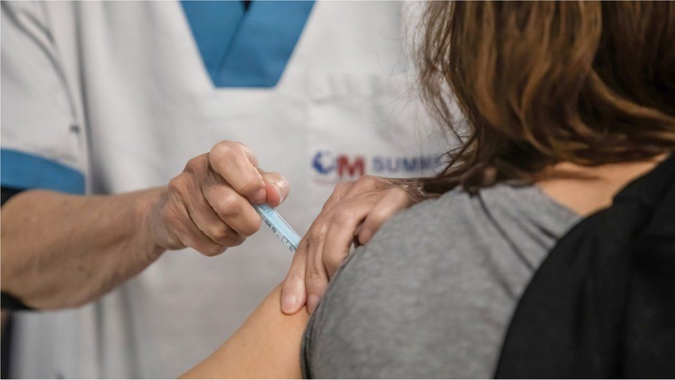 A woman receives an AstraZeneca shot in Madrid