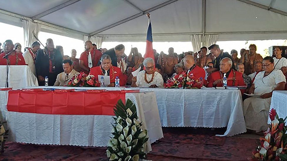 Fiame Naomi Mata'afa (seated C-in white) sits with members of parliament and the judiciary as she is sworn in as Samoa's first woman prime minister in Apia on May 24, 2021, at an extraordinary makeshift tent ceremony after the island nation's long-ruling government refused to cede power and locked the doors of parliament.