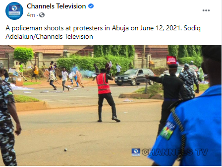 Photo of policeman shooting teargas at June12 protesters in Abuja