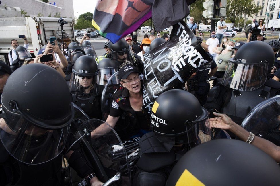 US Capitol Police in riot gear surround a counter-protester