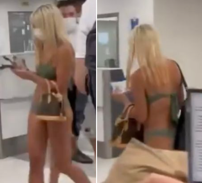 Moment woman strolls through airport in just a bikini and face mask