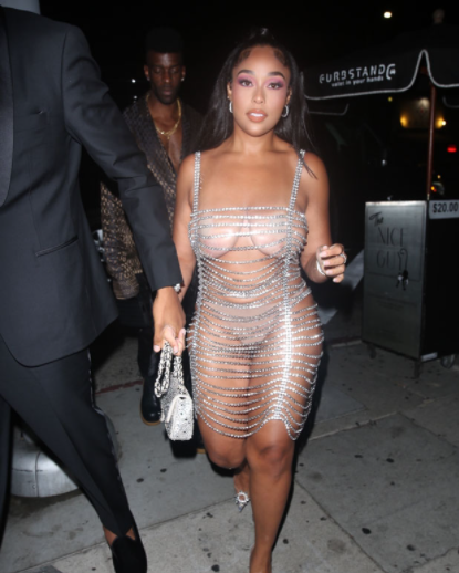 Jordyn Woods steps out in crystal chain dress that leaves her boobs and butt exposed 