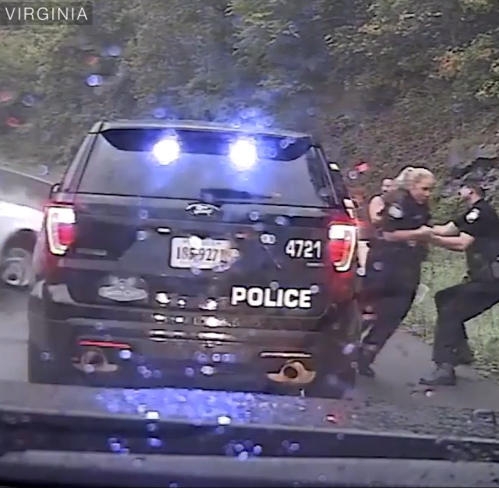 Moment police officer pulled his colleague out of harm