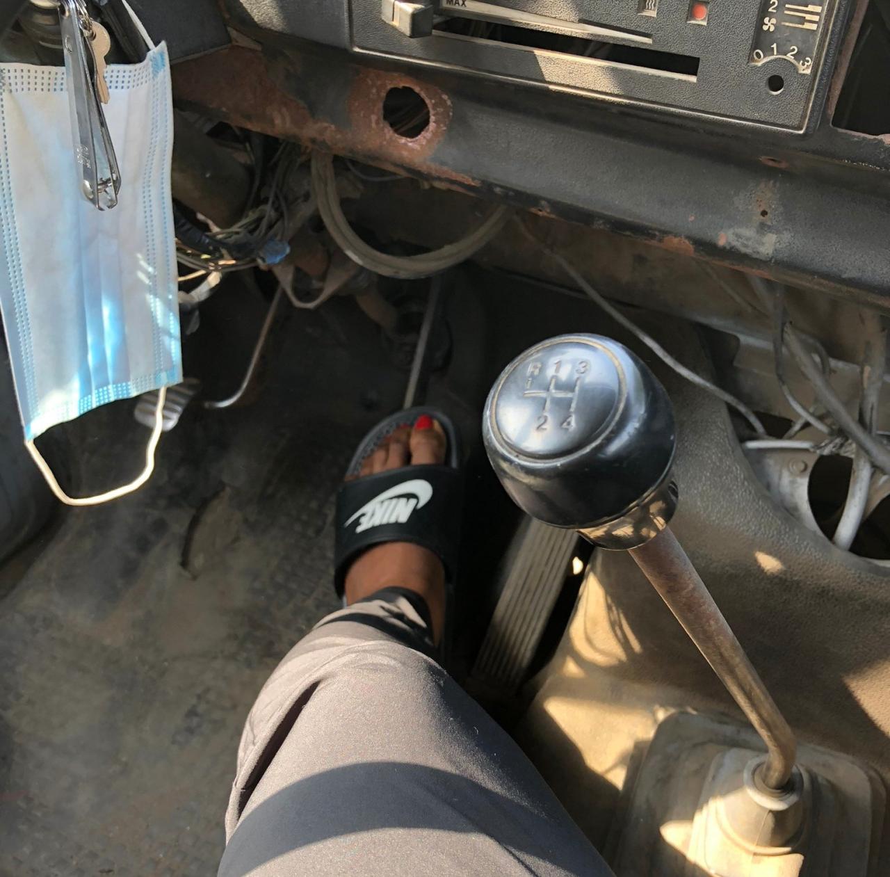 Female passenger pictured stepping on brake of commercial bus after the driver left the bus to fight another road user
