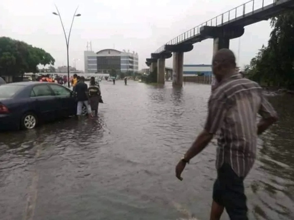 Youths bring out net to fish close to government house in Rivers state as streets flood following heavy rain
