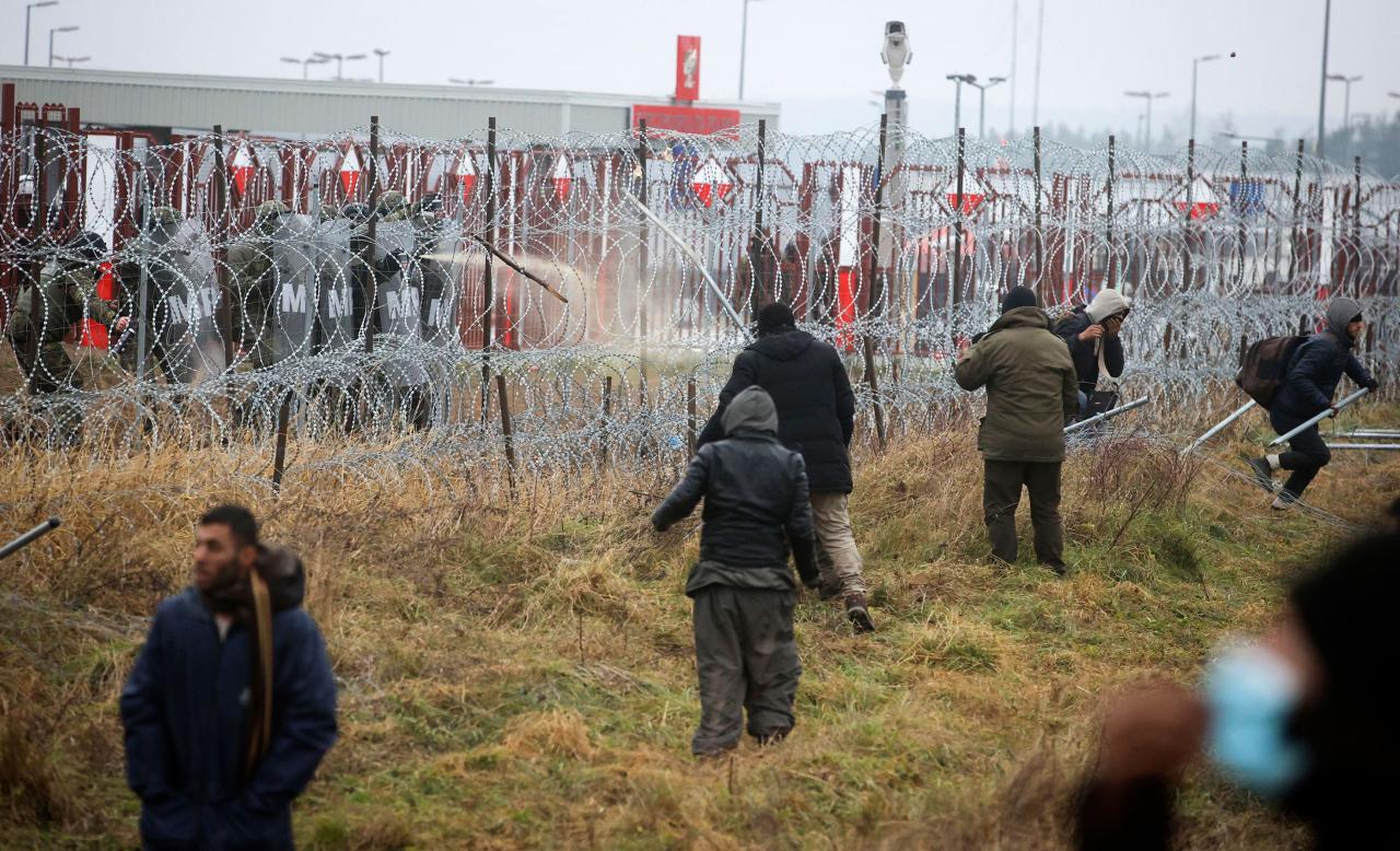 Watch Polish military use water cannons and tear gas on migrants as tensions rise at EU