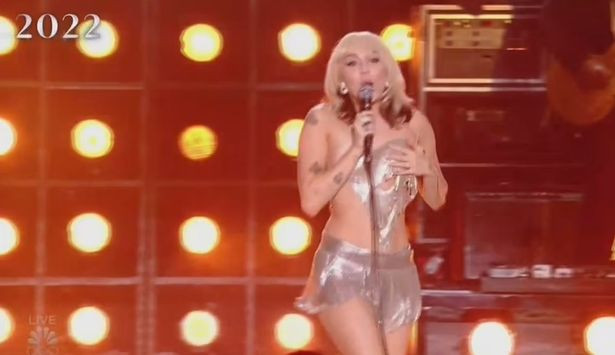 Miley Cyrus suffers wardrobe malfunction as her skimpy top breaks and partly falls off on stage 
