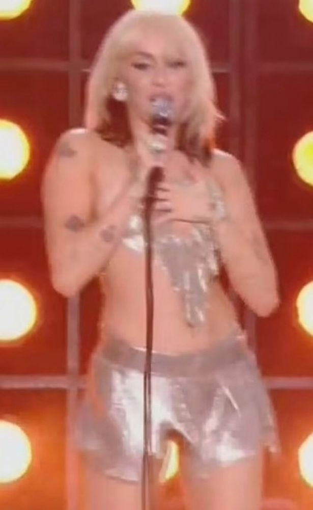 Miley Cyrus suffers wardrobe malfunction as her skimpy top breaks and partly falls off on stage 