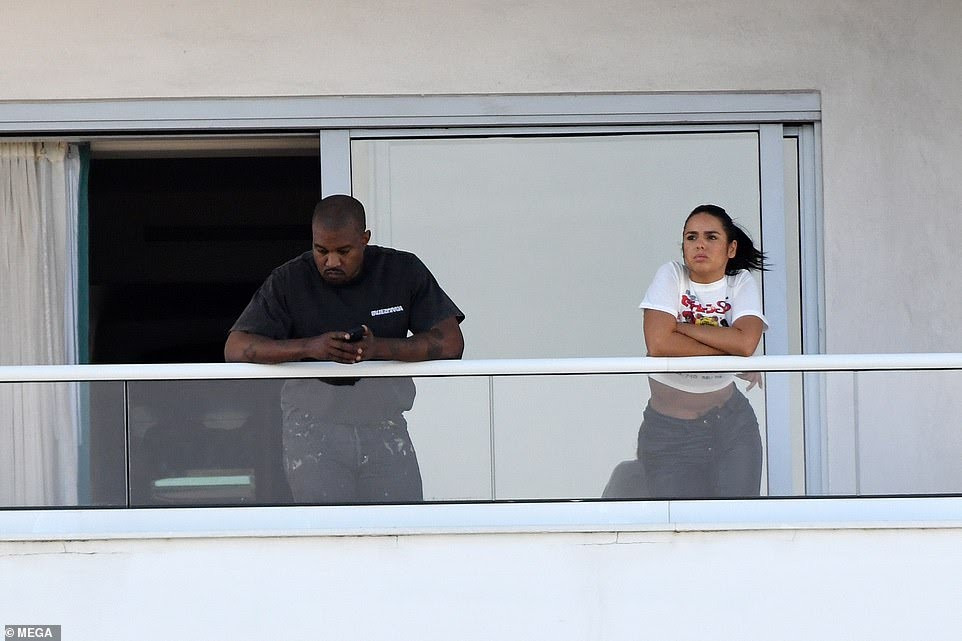 Kanye West spotted with mystery girl on hotel balcony before almost naked woman steps out of same hotel balcony (photos)