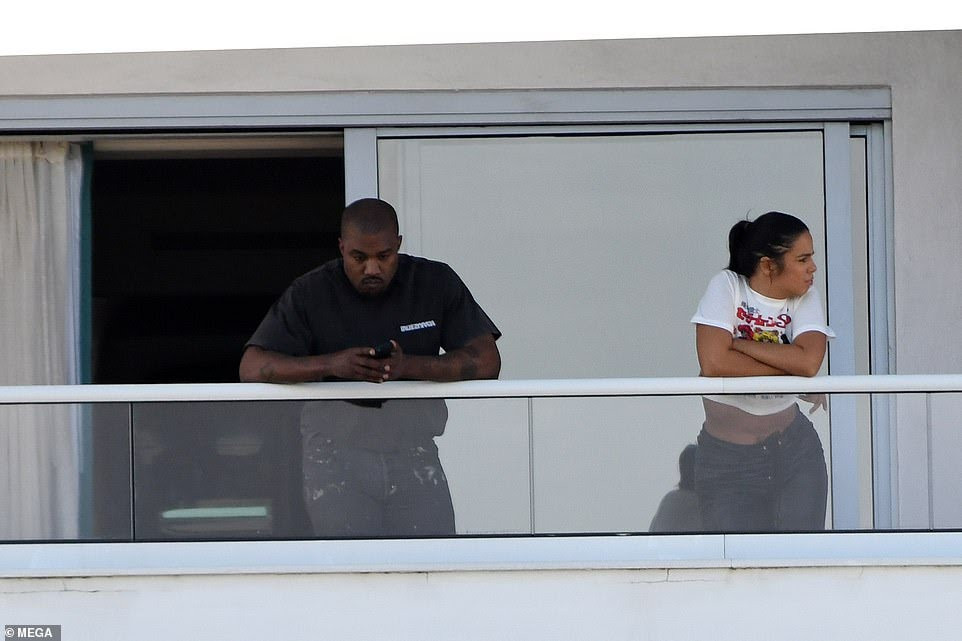 Kanye West spotted with mystery girl on hotel balcony before almost naked woman steps out of same hotel balcony (photos)
