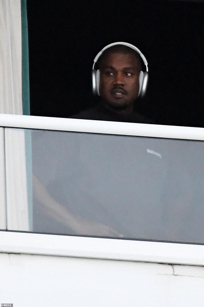 Kanye West spotted with mystery girl on hotel balcony before almost naked woman steps out of same hotel balcony (photos)