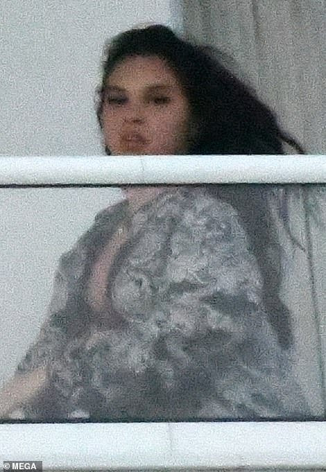 Kanye West spotted with mystery girl on hotel balcony before almost naked woman steps out of same hotel balcony (photos)