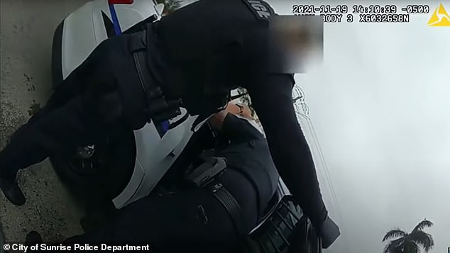Watch moment police man grabbed female colleague by the throat and shoved her into patrol car after she tried to pull him off suspect (video)