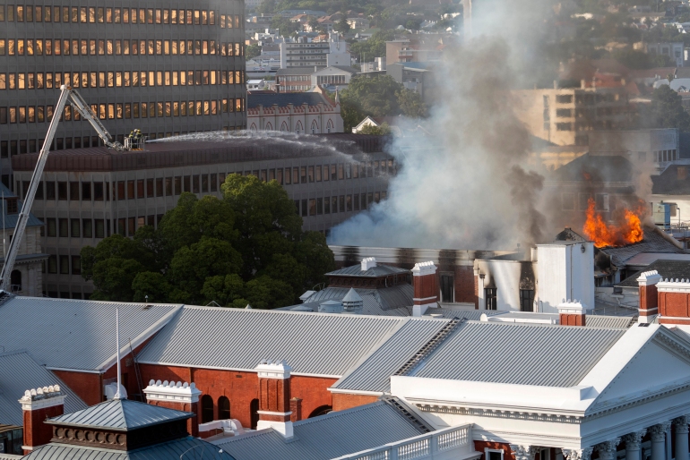 Firemen spray water on flames erupting from the South Africa's Parliament building.