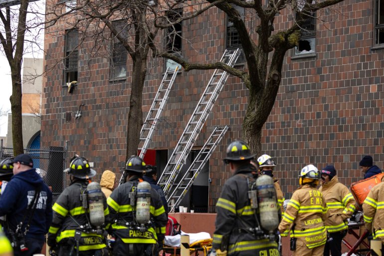 Ladders erected beside the apartment building where a fire occurred