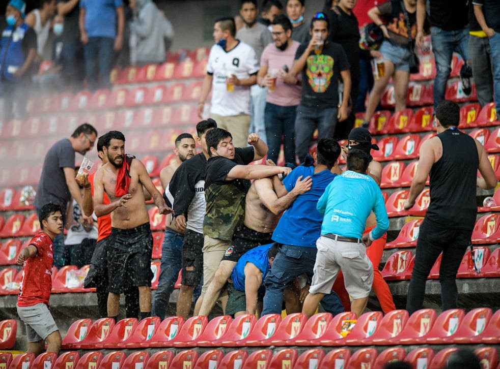 "17 reported dead" and 22 injured in brawl between rival fans at Mexican football match
